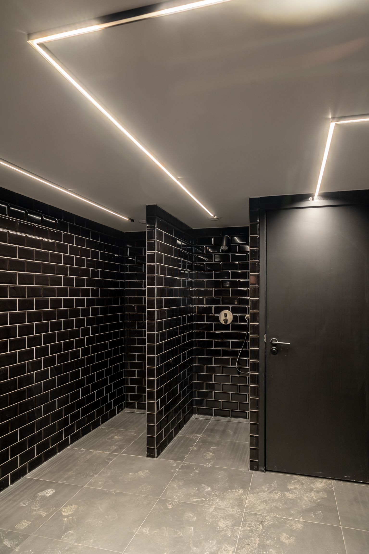 Hotel SuperRebel after renovation — black tile shower detail